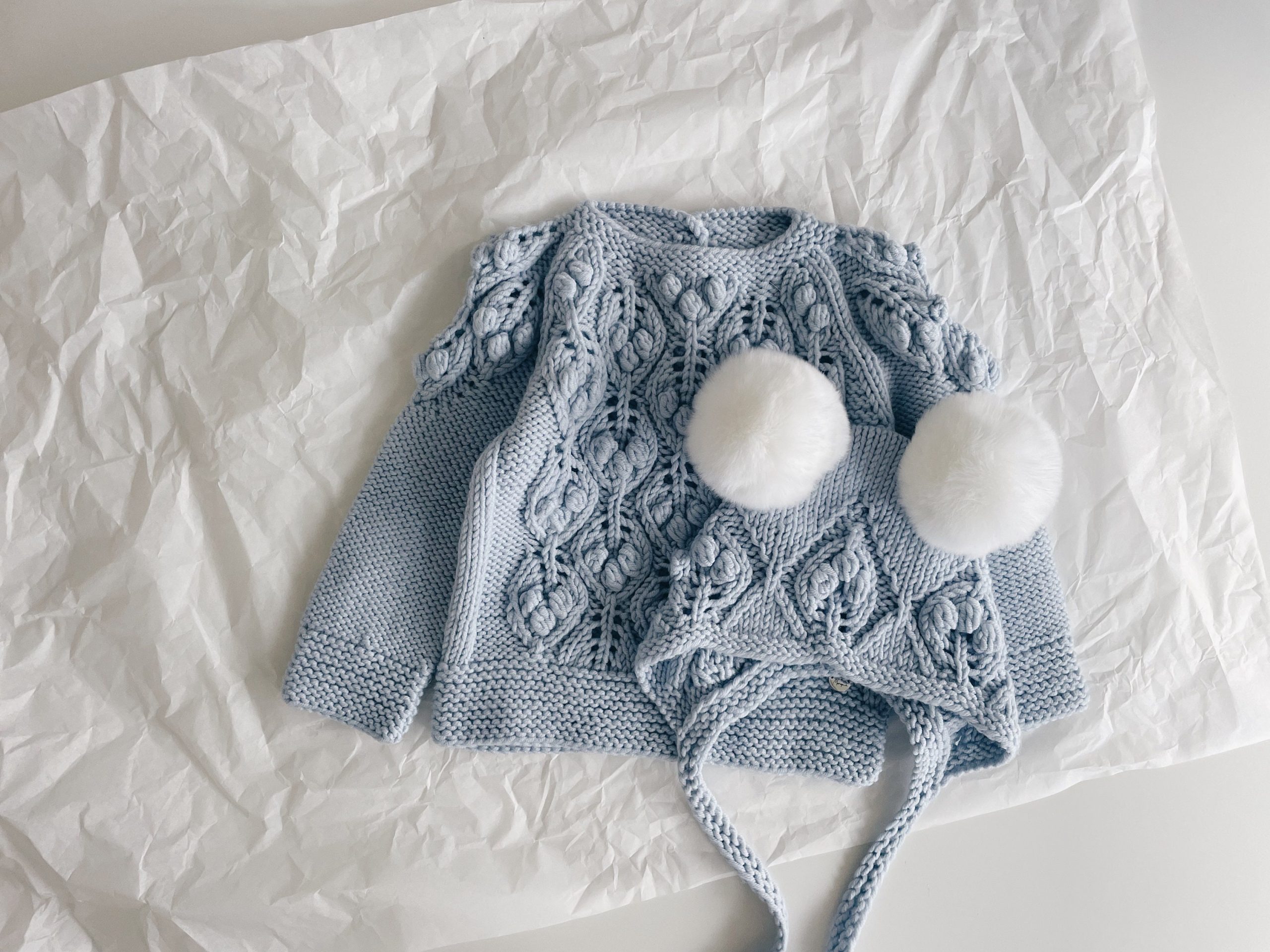 il_fullxfull.5392587649_trz4 Pale Blue Merino Baby Sweater and Bonnet Set – Fur Pom Poms - Image 1