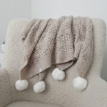Hand-Knitted Beige Alpaca Baby Blanket – Pom Pom Accent